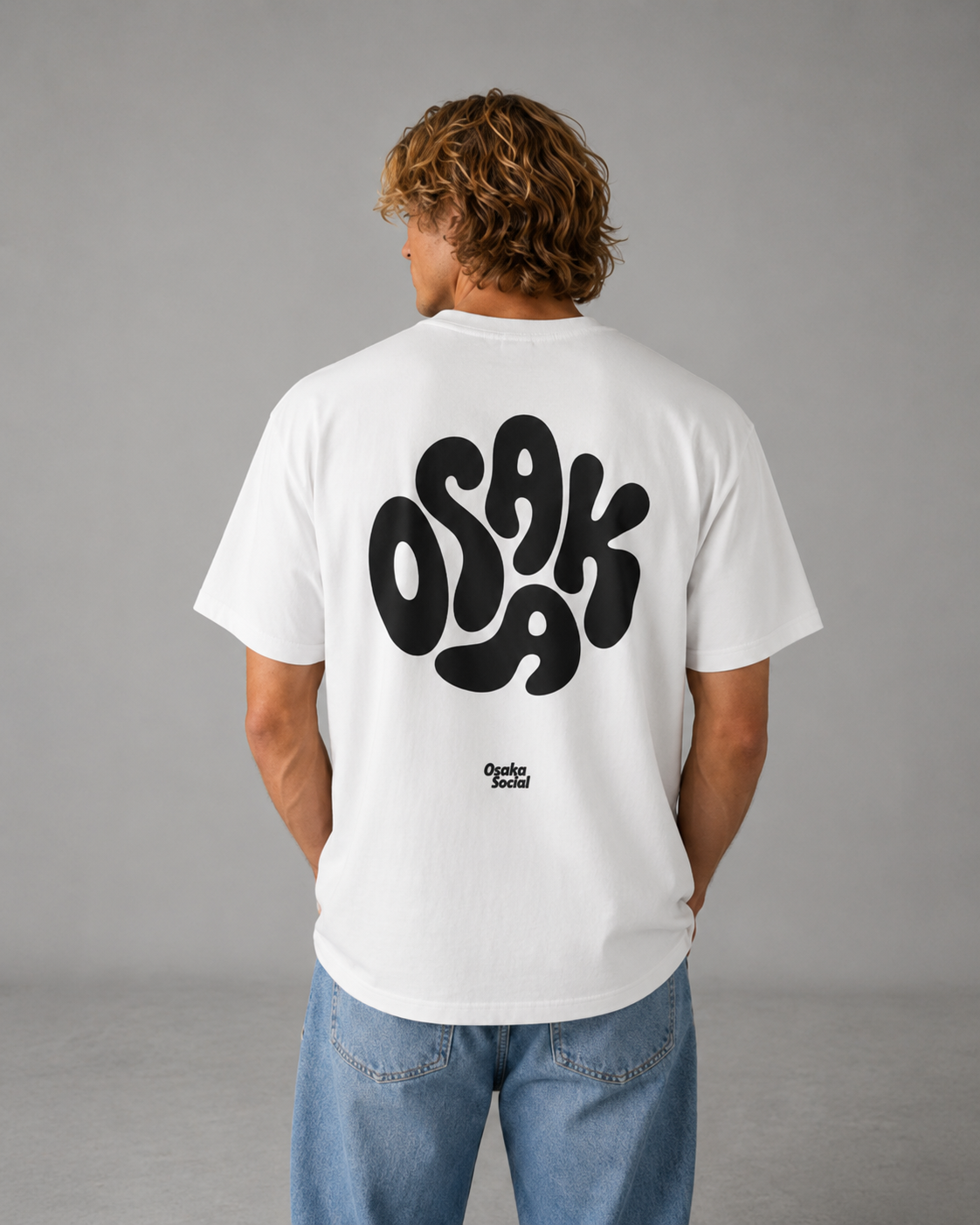 Male model facing away from the camera poses with osaka social shirt
