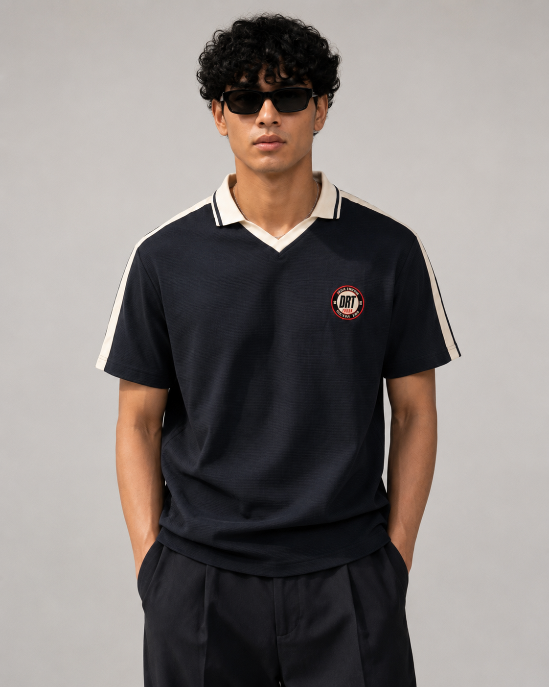 Male model wearing Dontonbori Racing Team polo in well lit studio room